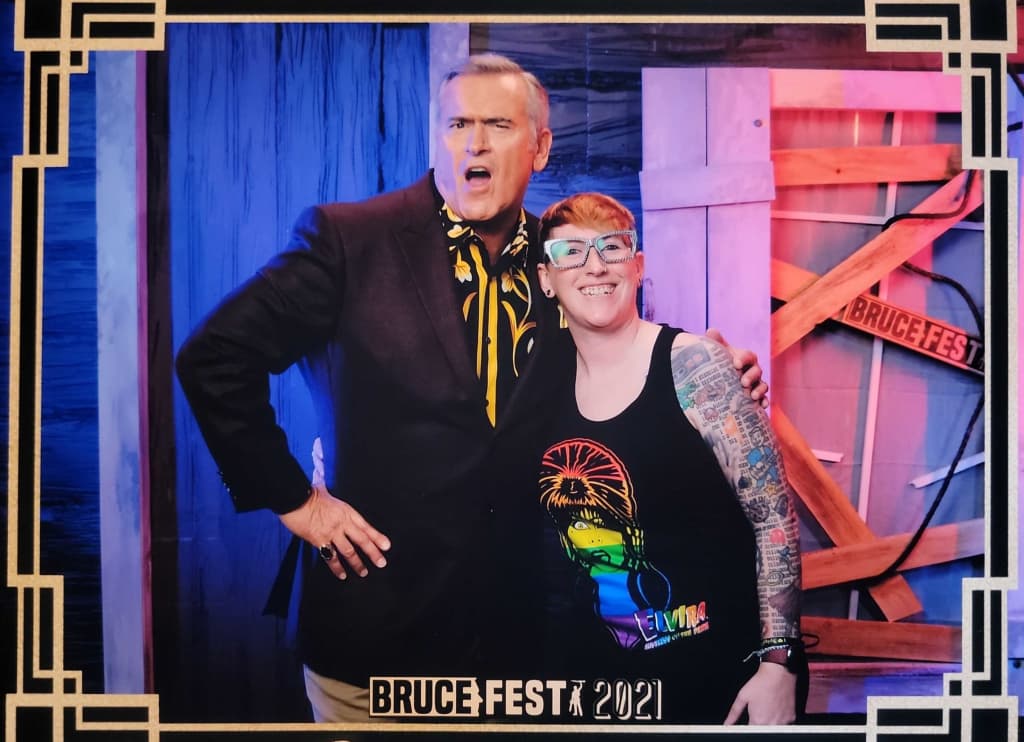 Fan and guest of BRUCEFEST poses with Bruce Campbell during a photo op